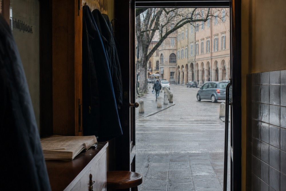 A dining room doorway with a handwritten reservation ledger on a small wooden desk