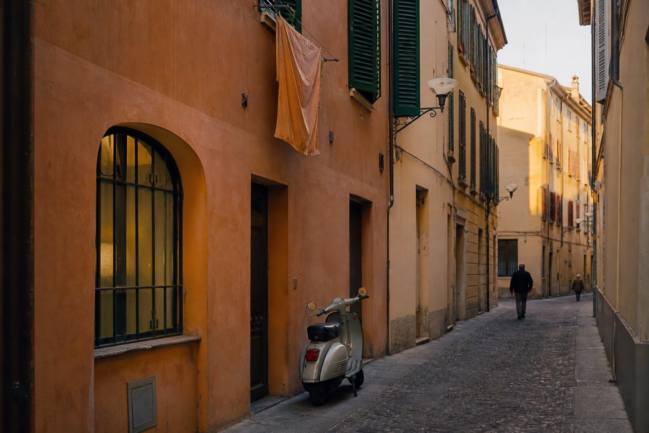 A quiet Modena street with ochre buildings and a bicycle leaning against a wall