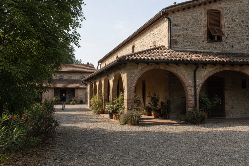 A historic Italian courtyard building on a quiet late-summer afternoon