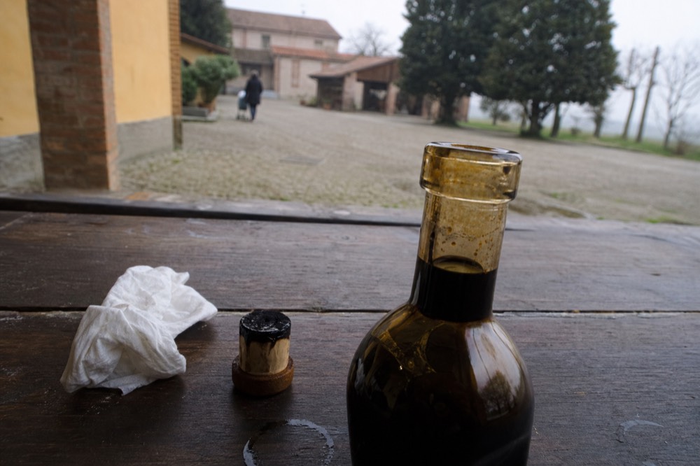 A close-up of a numbered seal and the Giugiaro bottle neck of Traditional Balsamic Vinegar of Modena DOP
