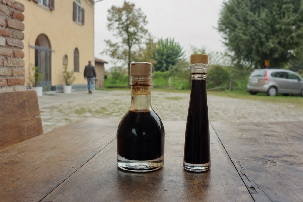 A real DOP bottle next to a counterfeit, showing the seal and the Giugiaro shape