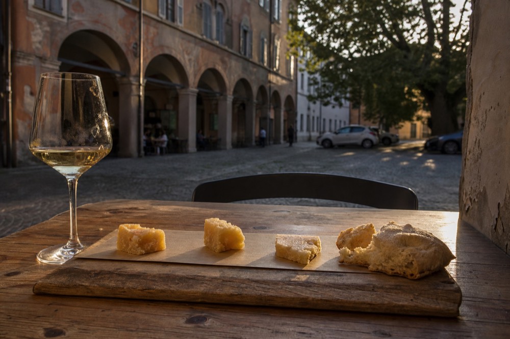 A tasting board of Parmigiano Reggiano chunks at different ages with bread
