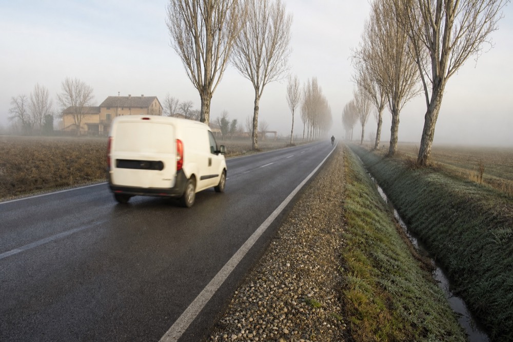 A country road between Modena and a dairy in the flat Emilian plain